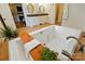 Modern bathroom with a large bathtub and wood accents, adjoining to the bedroom at 725 Bradshaw Rd, Mt Ulla, NC 28125