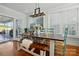 Light-filled dining room offers a large table, bench seating and sliding doors to the porch at 725 Bradshaw Rd, Mt Ulla, NC 28125