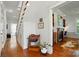 Hallway with hardwood floors, staircase, and access to a living room space at 725 Bradshaw Rd, Mt Ulla, NC 28125