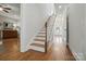 Bright hallway featuring hardwood floors, a staircase, and access to multiple rooms at 725 Bradshaw Rd, Mt Ulla, NC 28125