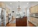Kitchen with custom cabinets, stainless appliances, and a center island at 725 Bradshaw Rd, Mt Ulla, NC 28125