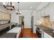 Charming kitchen boasts stainless appliances, stone countertops, hardwood floors and modern lighting at 725 Bradshaw Rd, Mt Ulla, NC 28125