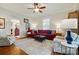 Inviting living room featuring hardwood floors, area rug, and a comfortable red sectional sofa at 725 Bradshaw Rd, Mt Ulla, NC 28125