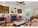 Cozy living room featuring a fireplace, built-in shelving, and hardwood floors at 725 Bradshaw Rd, Mt Ulla, NC 28125