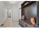 This mudroom features tiled floors, a coat rack, a refrigerator, and access to the front door at 725 Bradshaw Rd, Mt Ulla, NC 28125