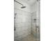 Shower featuring a rainfall shower head and white tile at 725 Bradshaw Rd, Mt Ulla, NC 28125