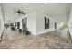 Expansive covered porch featuring seating, ceiling fans, and a concrete floor at 725 Bradshaw Rd, Mt Ulla, NC 28125