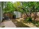 The backyard features a storage shed, wood fence, and shady trees at 7309 Pebblestone Dr # D, Charlotte, NC 28212