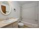 This bathroom includes a vanity with a sink, toilet and a shower-tub combination at 7309 Pebblestone Dr # D, Charlotte, NC 28212