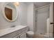 Clean bathroom featuring a vanity with sink, toilet, and enclosed shower at 7309 Pebblestone Dr # D, Charlotte, NC 28212