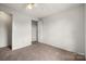 Bedroom featuring a ceiling fan, neutral carpet, and a closet at 7309 Pebblestone Dr # D, Charlotte, NC 28212