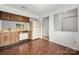 Kitchen with wood cabinets, white refrigerator and window to living room at 7309 Pebblestone Dr # D, Charlotte, NC 28212