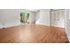 Living room with wood floors, sliding doors to a patio, and a staircase at 7309 Pebblestone Dr # D, Charlotte, NC 28212