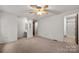 Bright main bedroom with ensuite bathroom, vanity, and neutral carpet at 7309 Pebblestone Dr # D, Charlotte, NC 28212