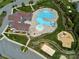 Aerial view shows a meticulously designed community pool area with clubhouse, playground, and volleyball court at 7412 Greene Mill Sw Ave, Concord, NC 28025