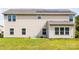 The backyard features a well-maintained lawn with several windows and solar panels enhancing the property's appeal at 7412 Greene Mill Sw Ave, Concord, NC 28025