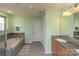Bathroom featuring a tub, shower, and a vanity with granite countertops and wood cabinets at 7412 Greene Mill Sw Ave, Concord, NC 28025