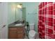 Functional bathroom with a granite vanity, toilet, and shower with a striking red and white patterned curtain at 7412 Greene Mill Sw Ave, Concord, NC 28025