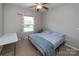 Cozy bedroom with a ceiling fan, a window with natural light, neutral carpet, and a comfortable double bed at 7412 Greene Mill Sw Ave, Concord, NC 28025