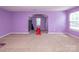 Bright bonus room with a play slide, neutral carpet, and natural light, ideal for recreation or entertainment at 7412 Greene Mill Sw Ave, Concord, NC 28025