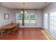 Light-filled dining area with french doors leading to the exterior and an adjacent window to the yard beyond at 7412 Greene Mill Sw Ave, Concord, NC 28025