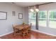Bright dining area features natural light, a chandelier, views to the backyard, and a wood table with four chairs at 7412 Greene Mill Sw Ave, Concord, NC 28025