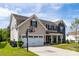 Lovely home featuring a 2 car garage, basketball hoop, and a manicured lawn at 7412 Greene Mill Sw Ave, Concord, NC 28025