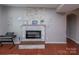 A cozy fireplace with a stacked stone surround and hearth at 7412 Greene Mill Sw Ave, Concord, NC 28025