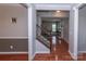 Open foyer featuring hardwood floors, staircase with wrought iron railings, and views of the living room at 7412 Greene Mill Sw Ave, Concord, NC 28025