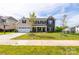 Traditional two-story home with a manicured lawn and well-maintained landscaping at 7412 Greene Mill Sw Ave, Concord, NC 28025