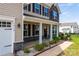 A well-maintained home featuring manicured landscaping and a welcoming front porch at 7412 Greene Mill Sw Ave, Concord, NC 28025