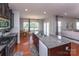 Open kitchen featuring a granite island, stainless steel appliances, and eat-in dining area with lots of natural light at 7412 Greene Mill Sw Ave, Concord, NC 28025