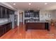 Spacious kitchen with stainless steel appliances, granite countertops, and a center island at 7412 Greene Mill Sw Ave, Concord, NC 28025