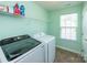 Laundry room featuring modern washer and dryer and storage shelf at 7412 Greene Mill Sw Ave, Concord, NC 28025