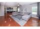 Spacious living room with hardwood floors, a ceiling fan, and a large sectional sofa at 7412 Greene Mill Sw Ave, Concord, NC 28025