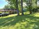Large grassy backyard with mature trees and landscaping at 7431 Idlewild Rd, Charlotte, NC 28212