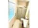 Small bathroom with a tiled shower and a window with blinds for natural light at 7431 Idlewild Rd, Charlotte, NC 28212