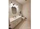 Cozy bathroom with hexagon tile flooring, traditional vanity, and a framed mirror at 7431 Idlewild Rd, Charlotte, NC 28212
