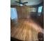 Wood-paneled bedroom with shelving, ceiling fan and hardwood floors at 7431 Idlewild Rd, Charlotte, NC 28212