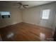 Bedroom with hardwood floors, ceiling fan and door to the exterior at 7431 Idlewild Rd, Charlotte, NC 28212