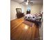 Comfortable bedroom with hardwood floors, ceiling fan, and vintage decor at 7431 Idlewild Rd, Charlotte, NC 28212
