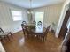 Comfortable dining room with wood floors, traditional furniture, and large windows at 7431 Idlewild Rd, Charlotte, NC 28212