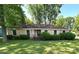Charming brick home featuring a well-maintained lawn and mature landscaping in a peaceful neighborhood at 7431 Idlewild Rd, Charlotte, NC 28212