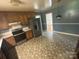 Functional kitchen with stainless steel refrigerator, oven and patterned floor at 7431 Idlewild Rd, Charlotte, NC 28212