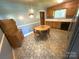 Eat-in kitchen with a vintage-style dining table, wood cabinets, and decorative hutch at 7431 Idlewild Rd, Charlotte, NC 28212