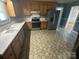 Kitchen featuring stainless steel refrigerator, oven and tile floors at 7431 Idlewild Rd, Charlotte, NC 28212