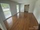 Spacious living room with hardwood floors and large windows at 7431 Idlewild Rd, Charlotte, NC 28212