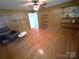 Spacious living room with shelving and hardwood flooring at 7431 Idlewild Rd, Charlotte, NC 28212
