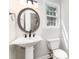 Charming bathroom with pedestal sink, modern fixtures, and a window with natural light at 781 Summerwood Dr, Rock Hill, SC 29732