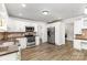 Well-lit kitchen featuring stainless steel appliances, white cabinets, and hardwood style flooring at 781 Summerwood Dr, Rock Hill, SC 29732